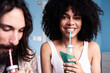 © IVAN GENER/Westend61 - Portrait of smiling young woman with boyfriend drinking smoothie