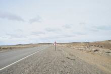Argentina, Patagonia, Empty Road With Exclamation Mark Sign In The Middle Of Desert