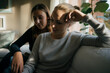 © Joseffson/Westend61 - Two teenage girls sitting on couch at home