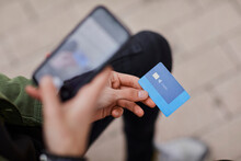 Man Taking Photo Of Credit Card Through Mobile Phone