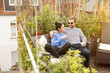 © Moll/Schoepgens Fotodesign GbR/Westend61 - Young couple relaxing on their balcony, sitting on couch