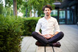 © philipp nemenz/Westend61 - Businessman doing yoga on a bench in the city