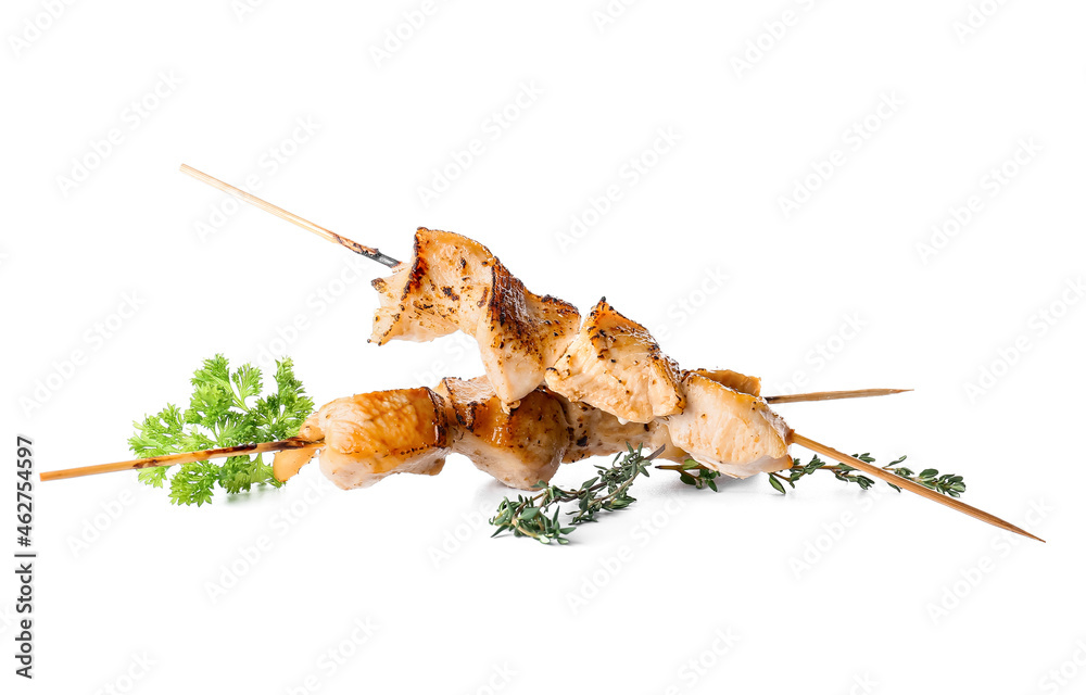 Grilled chicken skewers on white background