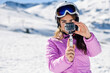 © Javier S√°nchez Mingorance/Westend61 - Woman in ski clothes filming with an action camera in snow covered-landscape
