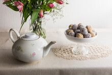 Jar With Blooming Flowers, Bowl Of Protein Balls And White Ceramic Teapot
