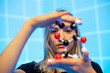 © Bernd Friedel/Westend61 - Close-up of young female scientist holding molecule model against blue grid pattern