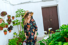 Spain, Cadiz, Vejer De La Frontera, Fashionable Woman Looking At Callas At Patio