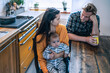 © Rich√°rd Bellevue/Westend61 - Serious family with baby sitting at kitchen table at home
