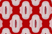 Pattern Of Bloodstained Sanitary Pads Against Red Background