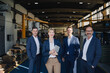 © KNSY/Westend61 - Portrait of confident business team standing in a factory