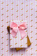 © gemma ferrando & jeremie roman/Westend61 - Two wrapped gifts against wrapping paper background