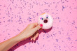 © gemma ferrando & jeremie roman/Westend61 - Hand of woman holding sweet doughnut with googly eyes