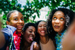 © Alexandra C. Ribeiro/Westend61 - Cheerful friends taking selfie at park
