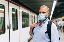 Businessman In Protective Face Mask At Subway Station