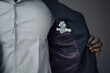 © KNSY/Westend61 - Crop view of businessman with toy robot in his jacket pocket