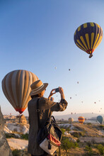 Young Woman And Hot Air Ballons, Goreme, Cappadocia, Turkey