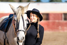 Portrait Of Smiling Woman With Horse In Paddock