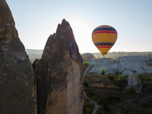 Hot Air Balloon On Mountain Against Clear Sky At Goreme, Cappadocia, Turkey