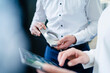 © Westend61 - Close-up of businessman and businesswoman with product and tablet having a work meeting