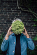 © Westend61 - Senior man holding a lettuce head in front of his face