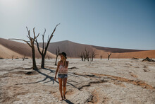 Namibia, Namib Desert, Namib-Naukluft National Park, Sossusvlei, Woman Walking In Deadvlei
