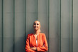 © Gustafsson/Westend61 - Thoughtful businesswoman with arms crossed against gray wall