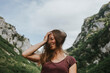 © David Molina Grande/Westend61 - Happy female trekker with tousled long brown hair against mountain range