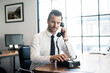 © steve brookland/Westend61 - Businessman in office using vintage retro telephone