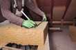 © Sebastian Dorn/Westend61 - Roof insulation, worker measuring wood fibre insulation