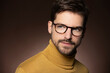 © Westend61 - Portrait of confident man wearing glasses and yellow sweater