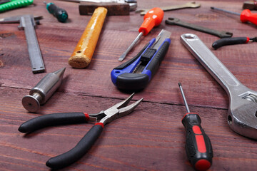 Poster - Variety of locksmith tools for repair work on wooden background.