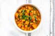 © Westend61 - Bowl of oriental pumpkin stew with red kuri squash, roasted turmeric chick-peas and parsley