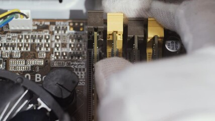 Close-up installing random access memory into modern motherboard for PC
