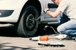 © Roman Maerzinger/Westend61 - Man changing car tire