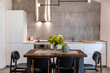 © Emma Innocenti/Westend61 - Dining table with chairs arranged in modern kitchen at home