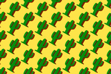Pattern Of Small Plastic Cacti Against Yellow Background