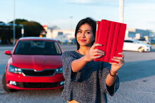 Beautiful Young Woman Taking Selfie With Digital Tablet Against Red Car On Sunny Day