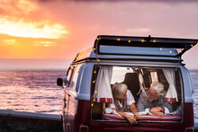Senior Couple Traveling In A Vintage Van, Lying In Boot