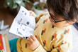 © VALENTINA BARRETO PHOTOGRAPHY/Westend61 - Little boy with glasses reading comic