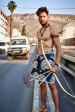 Tribal Man With His Traditional Arch And Arrows In The Middle Of The City With Cars Passing By, Lubango, Angola