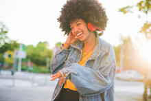 Happy Young Woman With Afro Hairdo Dancing In The City