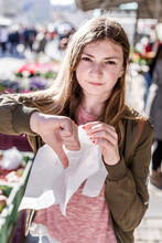 Girl With Plastic Bag Showing Thumb Down