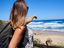 Backpack Woman Pointing With Her Finger Out To The Ocean, Robberg Nature Reserve, South Africa