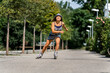 © Stefan Schurr/Westend61 - Smiling young woman riding inline skates