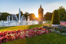 Germany, Mannheim, Friedrichsplatz With Fountain And Water Tower In The Background By Sunset