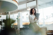 © Joseffson/Westend61 - Smiling businesswoman using digital tablet while sitting on table at cafe
