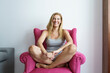 © Javier Sanchez Mingorance/Westend61 - Cheerful mature woman sitting on armchair at home