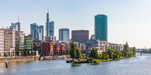 Buildings And Westhafen Tower By River Against Clear Sky In Frankfurt, Germany