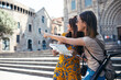 © JOSEP SURIA/Westend61 - Friends studying map while standing at Barcelona Cathedral Square in Barcelona, Catalonia, Spain