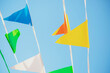 © Michael Malorny/Westend61 - Colourful pennons in blue sky